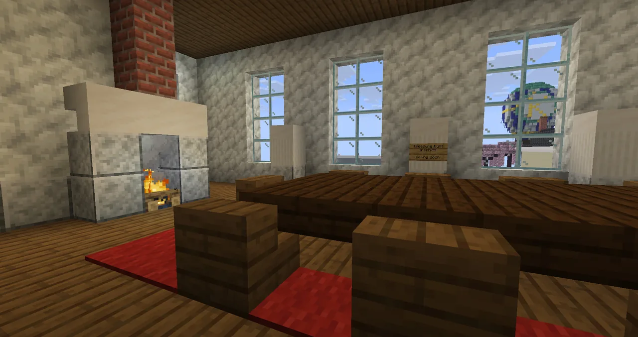 The council room on the town hall's first floor: a long table, a red carpet and a lit fireplace.